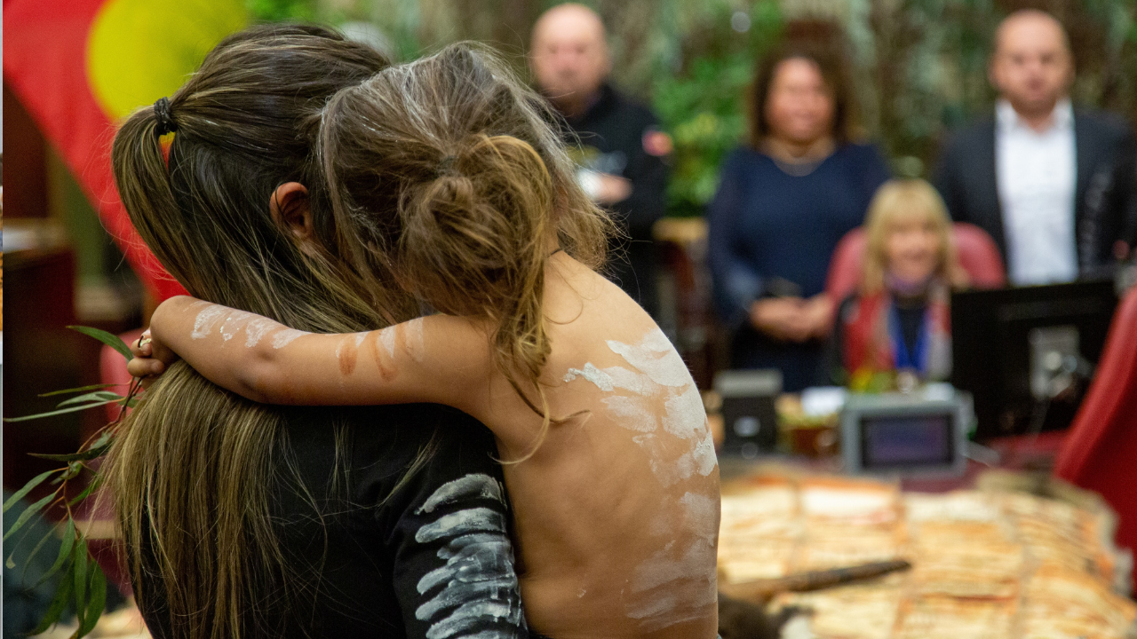 Aboriginal woman holding young child