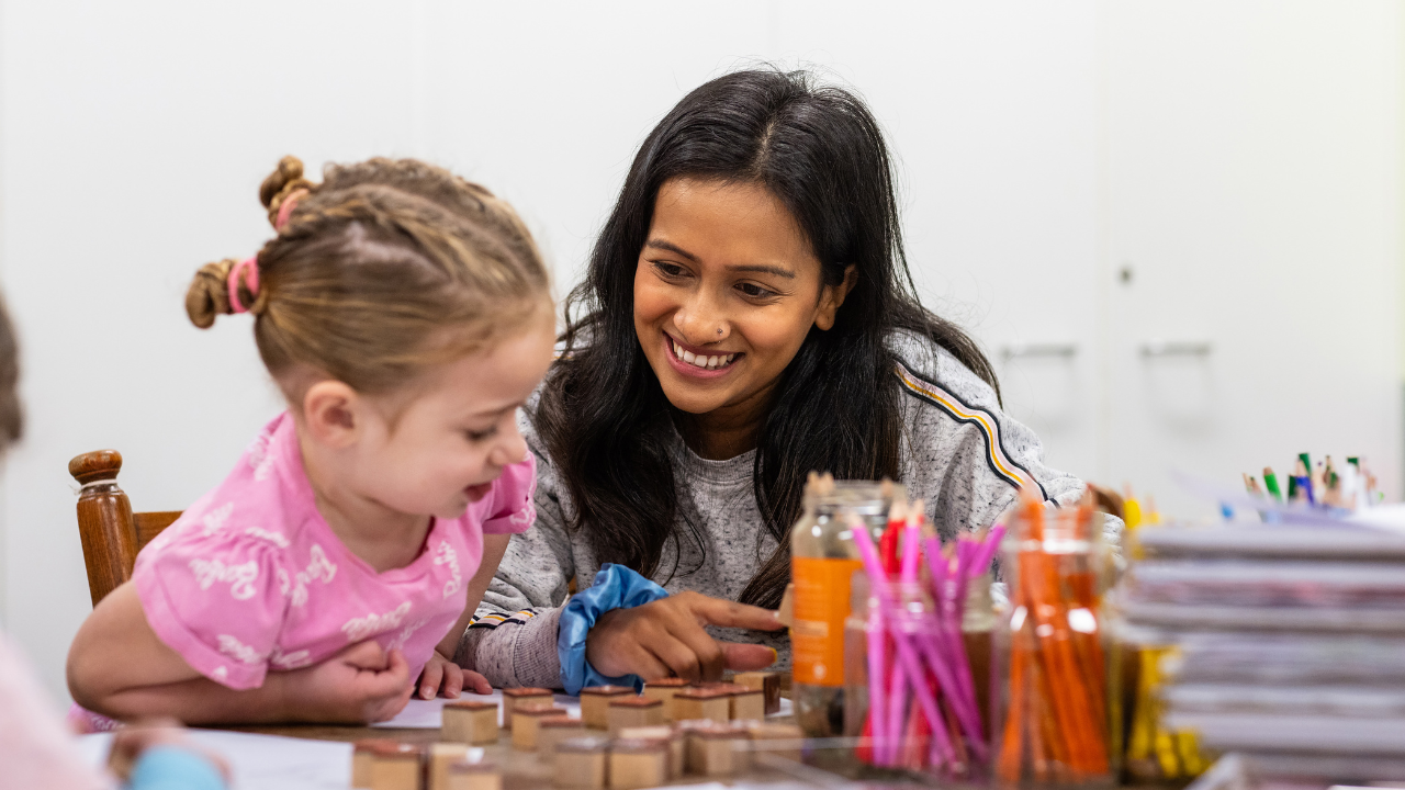 Child care worker playing with young girl