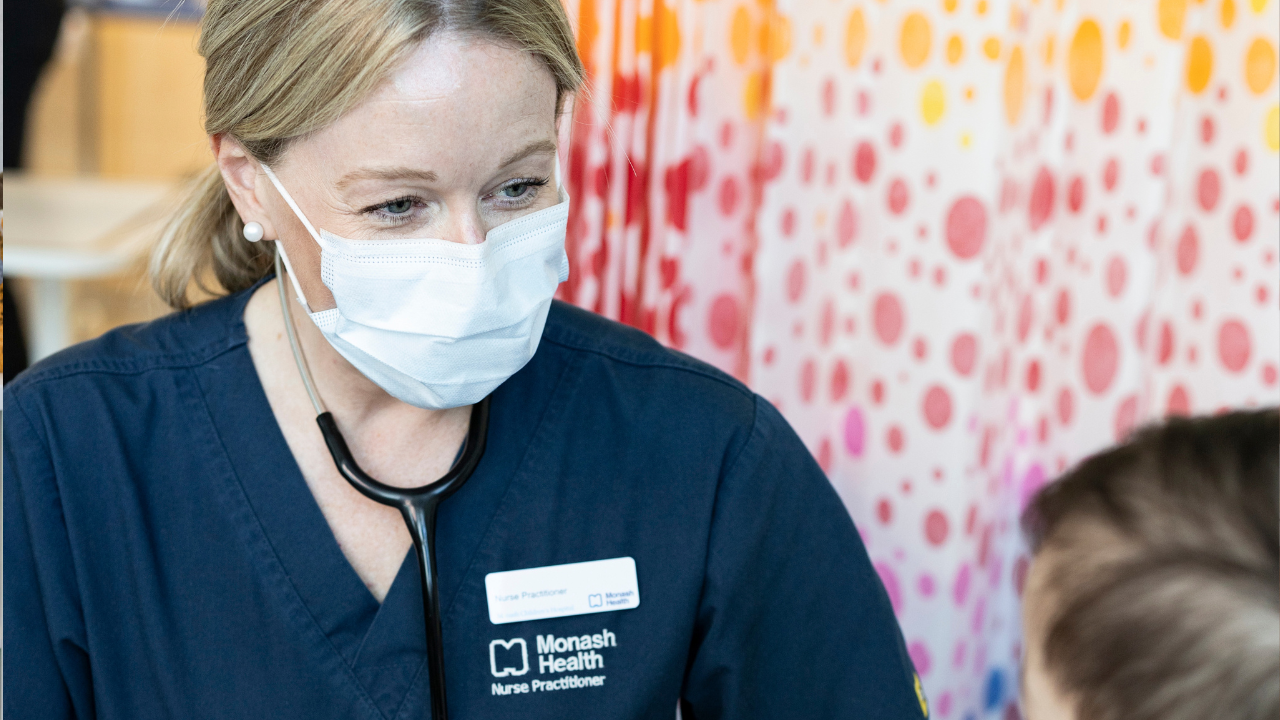 Female nurse treating young child in hospital