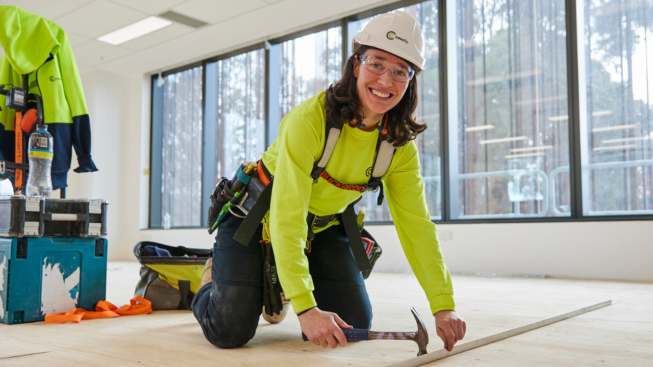 Tradesperson working inside on a floor