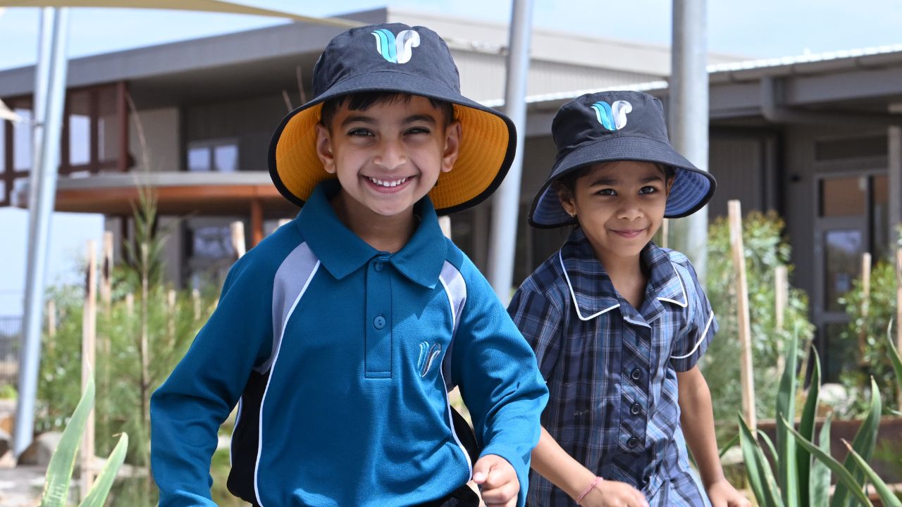 Two primary school students playing outside a school